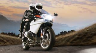 Couple on motorcycle in protective gear
